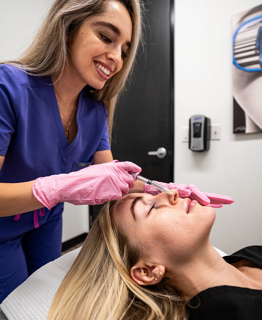 An injector treating a patient at Coastal Medical Aesthetics